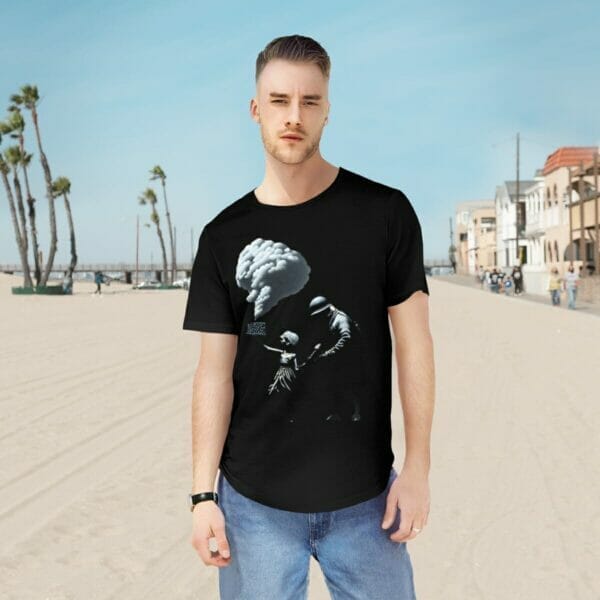 A man wearing a Banksy-inspired street art t-shirt stands on the beach. A man wearing a Banksy-inspired street art t-shirt stands on the beach.