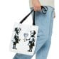 A Street Art Durable Tote Bag featuring two girls holding balloons.