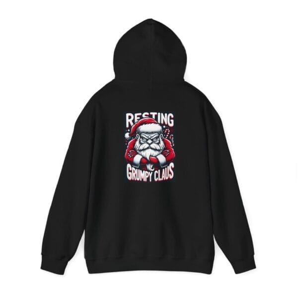 Black Grumpy Santa Claus Unisex Heavy Blend™ Hooded Sweatshirt featuring a graphic of a grumpy Santa and the text "Resting Grumpy Claus.