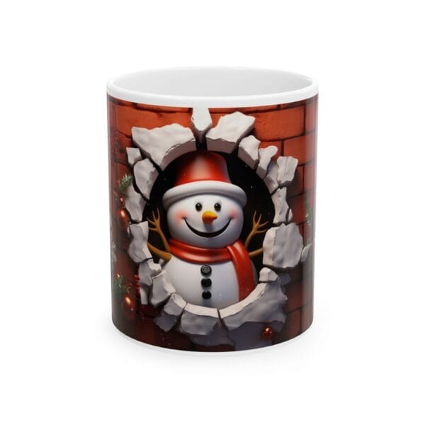 The Happy Snowman Ceramic Mug showcases a cheerful snowman breaking through a brick wall, adorned with a red scarf and hat, available in both 11oz and 15oz sizes.