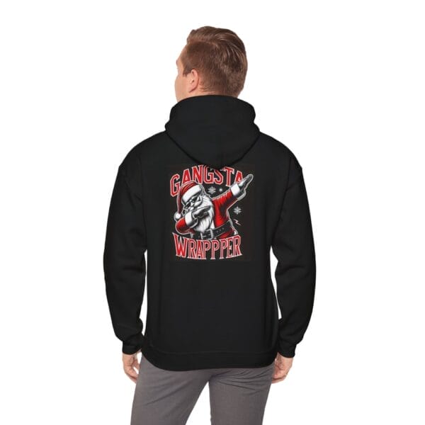 Individual dressed in a black "Gangster Wrapper Santa Unisex Heavy Blend™ Hooded Sweatshirt," featuring a dabbing Santa graphic and the phrase "Gangsta Wrapper" on the back. Individual dressed in a black "Gangster Wrapper Santa Unisex Heavy Blend™ Hooded Sweatshirt," featuring a dabbing Santa graphic and the phrase "Gangsta Wrapper" on the back.