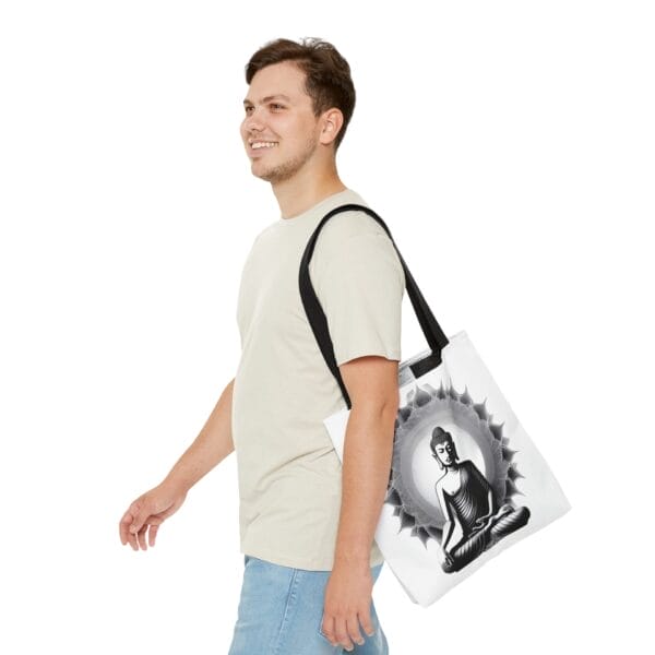 A person wearing a light beige t-shirt and blue jeans carries the stylish Buddha Tote Bag (AOP) featuring an illustration of Buddha. A person wearing a light beige t-shirt and blue jeans carries the stylish Buddha Tote Bag (AOP) featuring an illustration of Buddha.