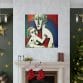 The Mother's Love Cubism Art Canvas hangs above a fireplace on white walls. Green walls with gold star decorations complement a Christmas tree on the right. Below the artwork, two red stockings complete this festive scene.