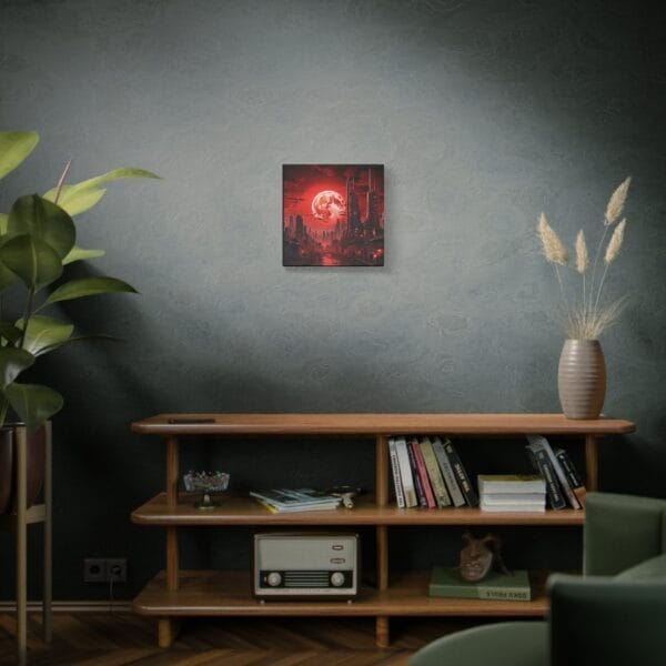 The "Blood Moon Over Ruins — Dystopian Cityscape Canvas, Stretched, 1.25"" artwork hangs on a dark green wall above a wooden shelf with books, a vase, a radio, and a potted plant nearby. The "Blood Moon Over Ruins — Dystopian Cityscape Canvas, Stretched, 1.25"" artwork hangs on a dark green wall above a wooden shelf with books, a vase, a radio, and a potted plant nearby.