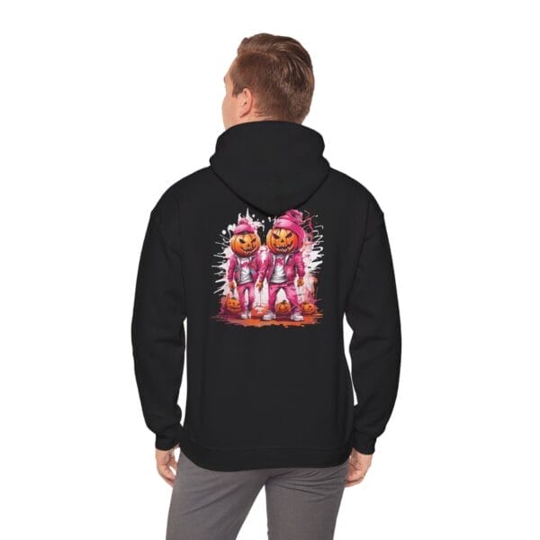 A man faces away, wearing the Halloween Street Pumpkin Men Unisex Heavy Blend™ Hooded Sweatshirt with a graphic of two pink pumpkin-headed astronauts amid Halloween-themed elements. A man faces away, wearing the Halloween Street Pumpkin Men Unisex Heavy Blend™ Hooded Sweatshirt with a graphic of two pink pumpkin-headed astronauts amid Halloween-themed elements.