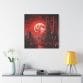 Blood Moon Over Ruins — Dystopian Cityscape Canvas, Stretched 1.25", hangs on a white wall above a cabinet with a yellow lamp, books, and a white vase of flowers. A vivid red moon dominates the futuristic cityscape art.