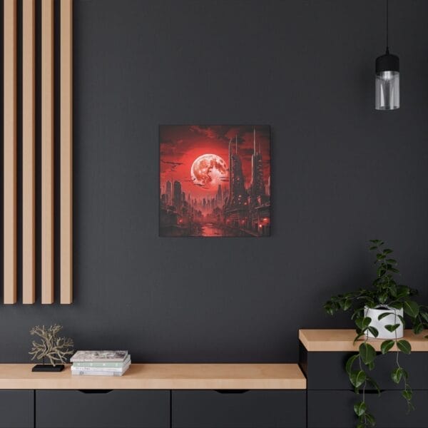 The Blood Moon Over Ruins — Dystopian Cityscape Canvas (stretched, 1.25") hangs on a dark wall above a wooden counter decorated with a potted plant, books, and ornaments. The Blood Moon Over Ruins — Dystopian Cityscape Canvas (stretched, 1.25") hangs on a dark wall above a wooden counter decorated with a potted plant, books, and ornaments.