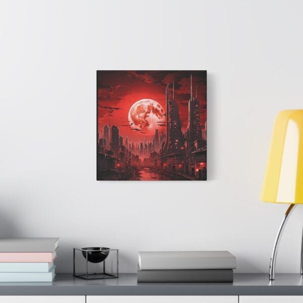 The Blood Moon Over Ruins — Dystopian Cityscape Canvas, Stretched 1.25", featuring a red moon and futuristic city, hangs on a white wall above a shelf holding books, a bowl, and a yellow lamp. The Blood Moon Over Ruins — Dystopian Cityscape Canvas, Stretched 1.25", featuring a red moon and futuristic city, hangs on a white wall above a shelf holding books, a bowl, and a yellow lamp.