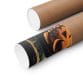 Two brown cardboard tubes with white end caps; one is partially unrolled, revealing a Halloween Pumpkin Art Print—a matte vertical poster featuring vibrant orange and black artwork for spooky fall decor.