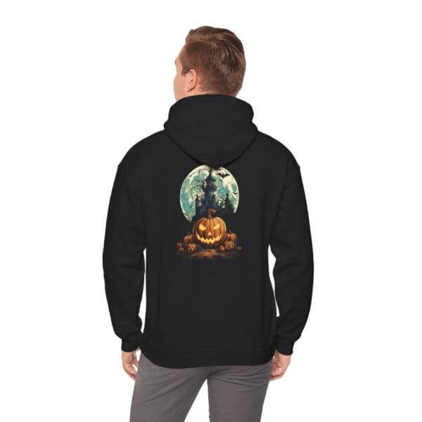 A man wears the Haunted Halloween Night Unisex Heavy Blend™ Hooded Sweatshirt, featuring a black hoodie with a pumpkin, bats, haunted house, and full moon graphic on the back. A man wears the Haunted Halloween Night Unisex Heavy Blend™ Hooded Sweatshirt, featuring a black hoodie with a pumpkin, bats, haunted house, and full moon graphic on the back.